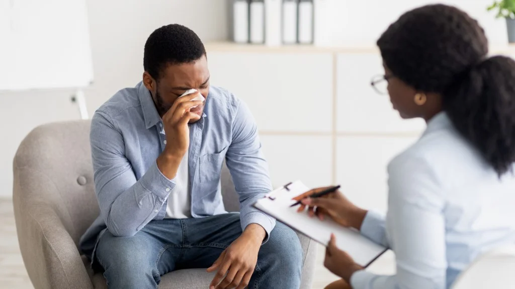 Male patient receiving depression treatment from therapist